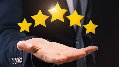 Unrecognizable Businessman Holding Five Stars Icons On Open Hand